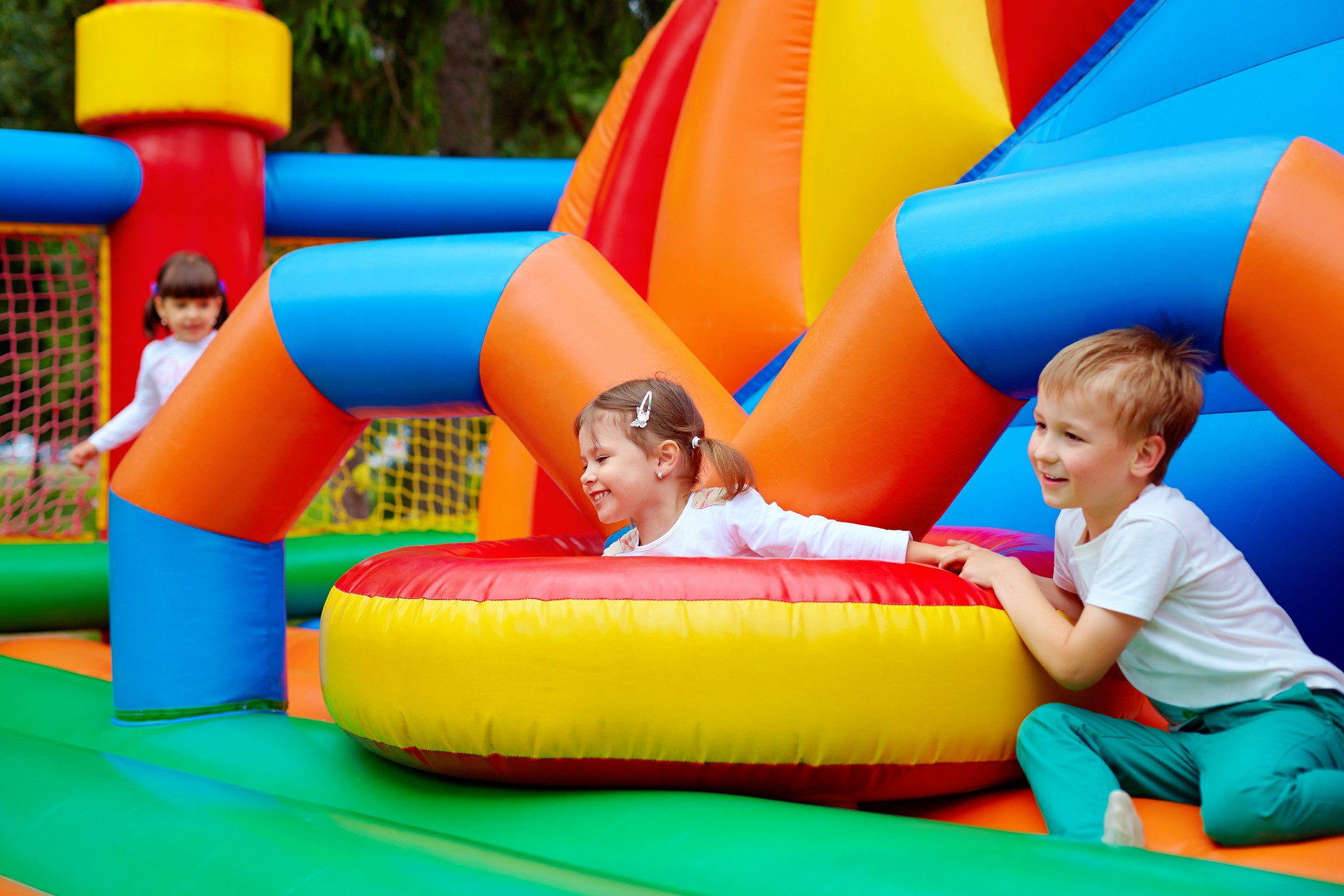 excited kids having fun on inflatable attraction playground